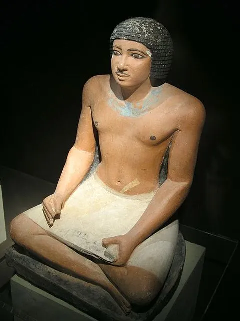 Seated statue of an Egyptian scribe holding a papyrus document in his lap, found in the western cemetery at Giza, Fifth dynasty of Egypt (25th to 24th centuries BC)